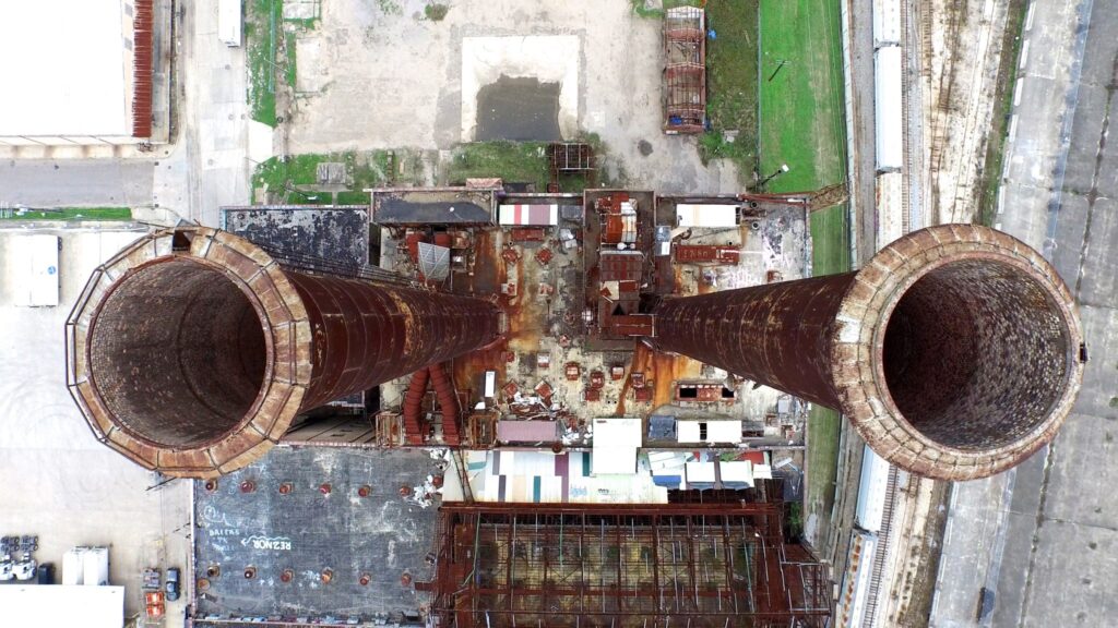 Looking down at two disused power station chimneys. Aerial drone footage. by Mark Westguard is licensed under CC-CC0 1.0